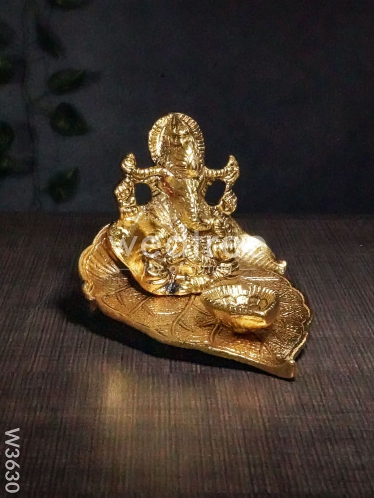 White Metal Ganesha in Pipal Leaf with Diya Gold Finish - W3630