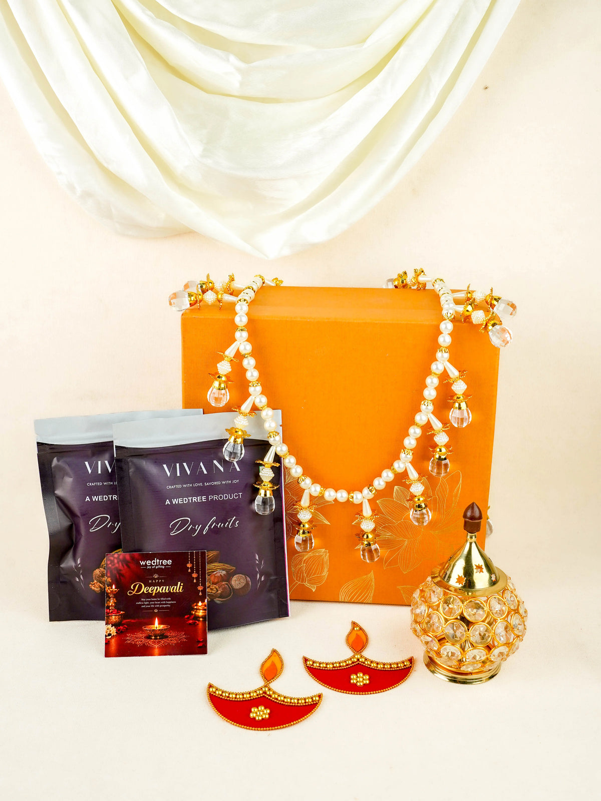 Deepavali: Box with Beads Thoran, Rangoli Diya, Crystal Diya & Dry Fruits - WDC0028