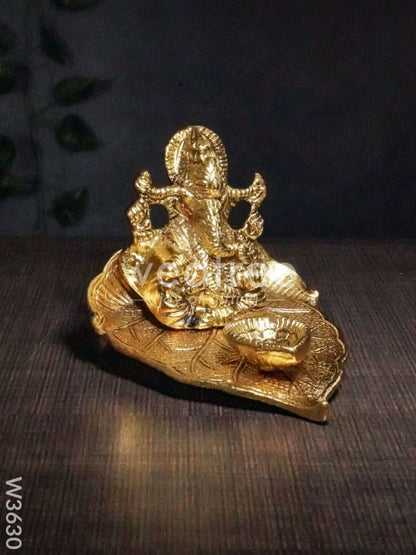White Metal Ganesha in Pipal Leaf with Diya Gold Finish - W3630